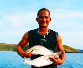 The Captain holds up two greys caught on June 2.